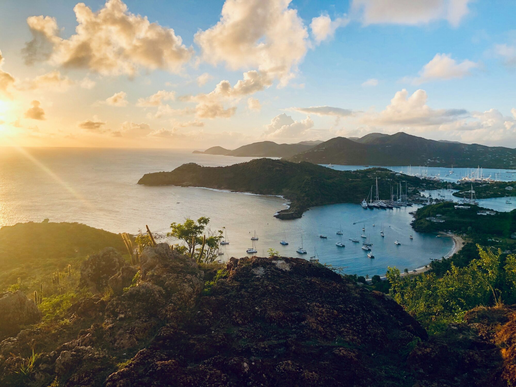 Luxury yachts silhouetted against a golden sunset on the beautiful Windward Islands - Horizon Luxury Crewed