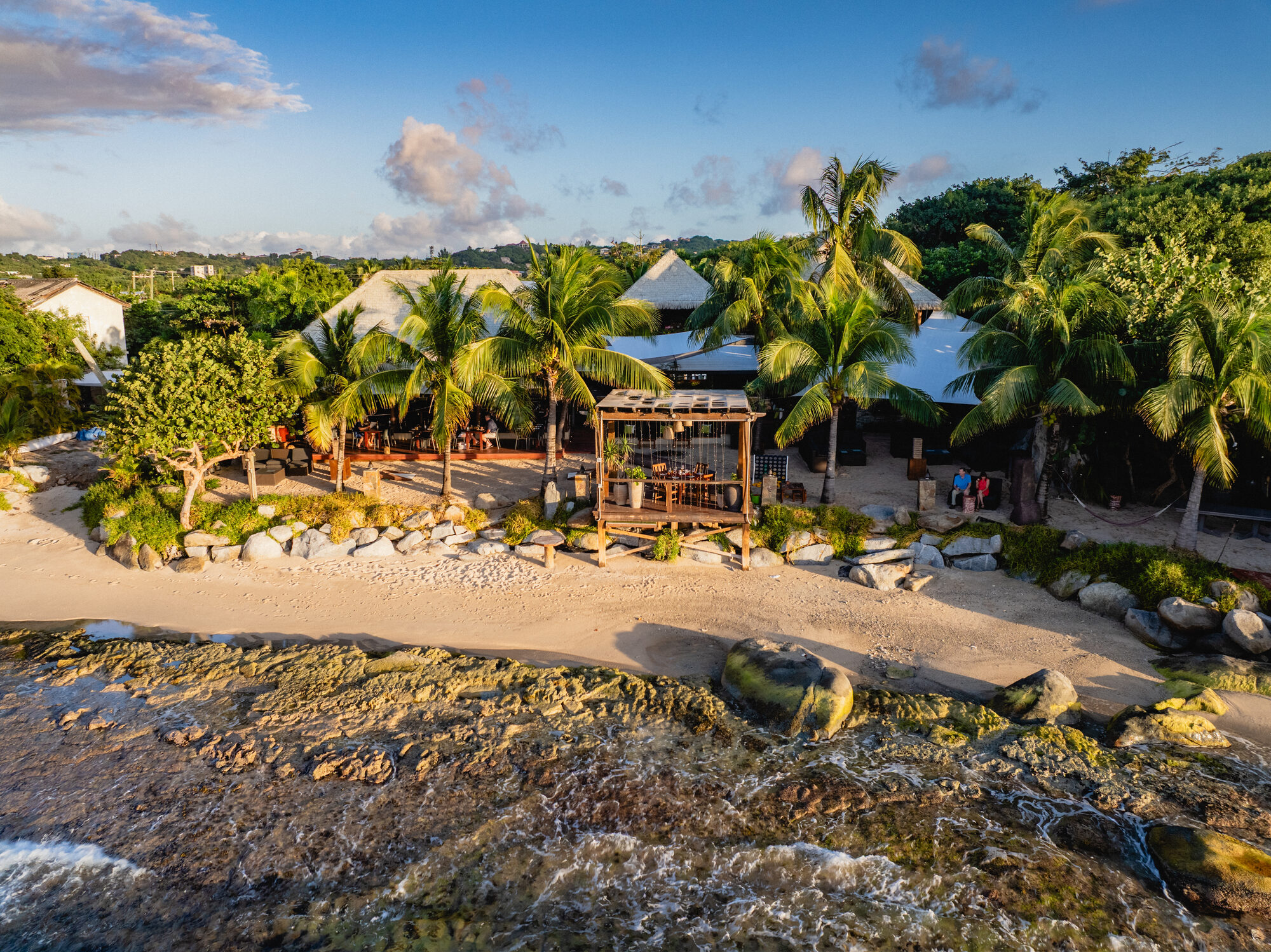 A dramatic rocky shoreline lapped by crystal-clear waters on a luxury crewed yacht journey - Horizon Luxury Crewed