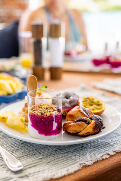 A beautifully presented yacht breakfast spread featuring granola, a yogurt pot and fresh pastries - Horizon Luxury Crewed