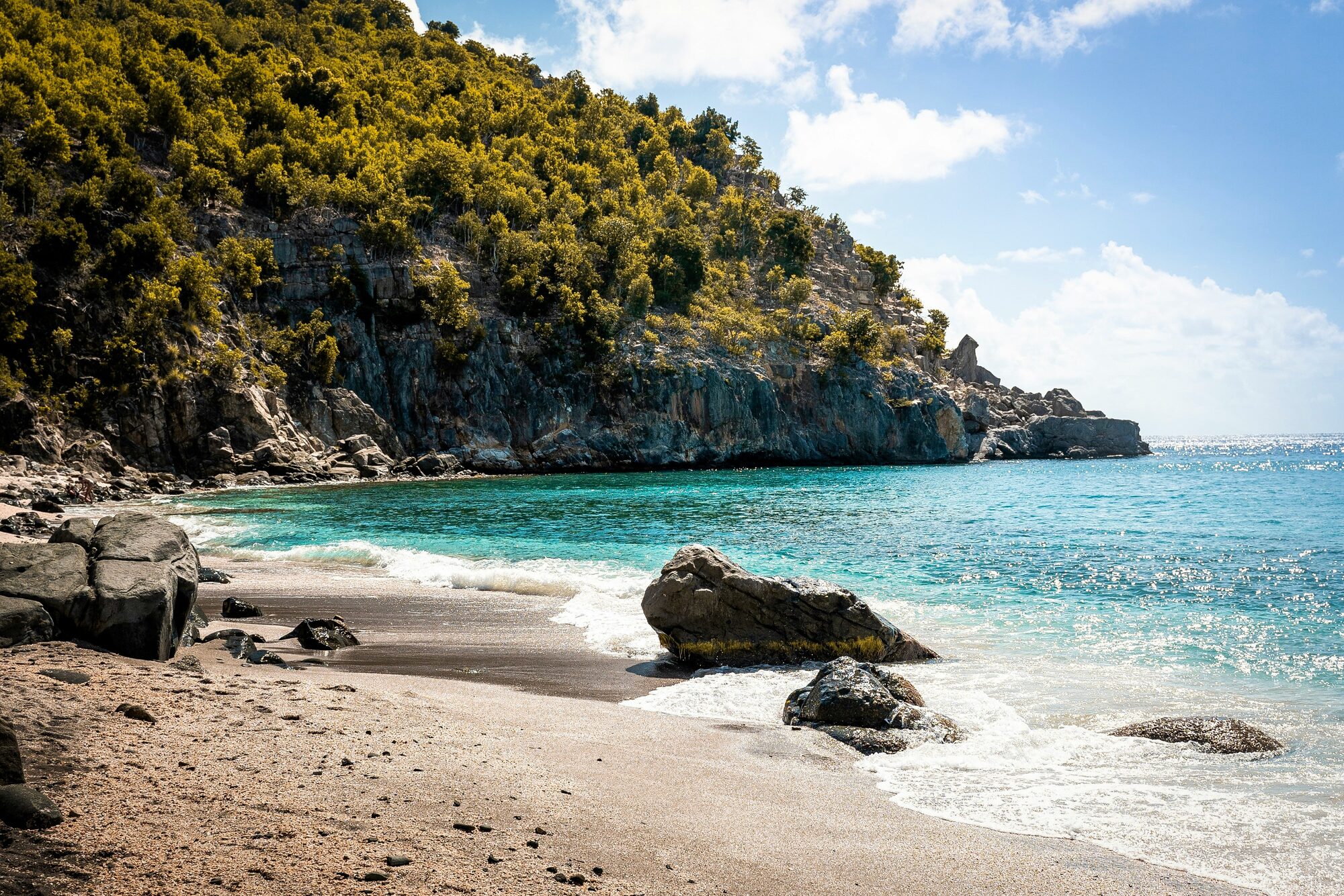 A rugged and dramatic rocky beach along the stunning coastline of the Leeward Islands - Horizon Luxury Crewed